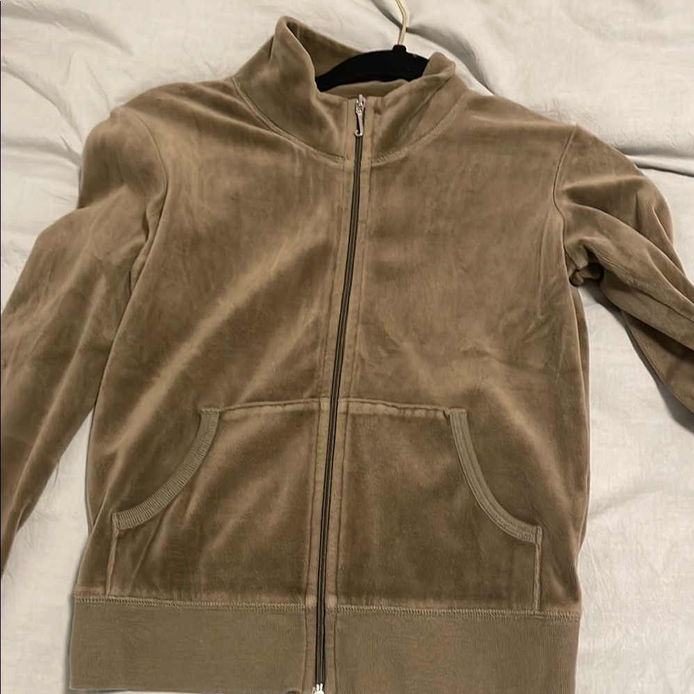 Brown Juicy Couture velour tracksuit jacket photographed flat on a bed